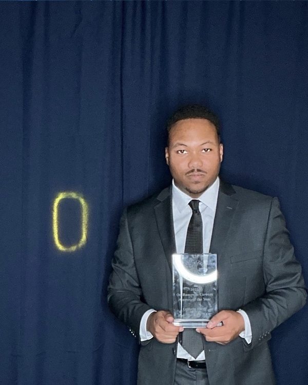 Larnelle Hardy holding the 2025 On-Ramps to Careers Alumni of the Year award